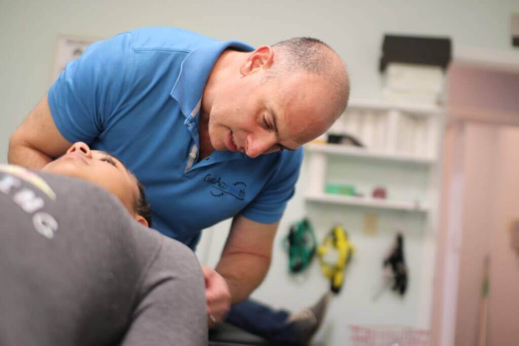 Dr. Neil doing an chiropractic adjustment to a woman patient