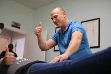 Dr. Neil giving a thumbs up to a patient
